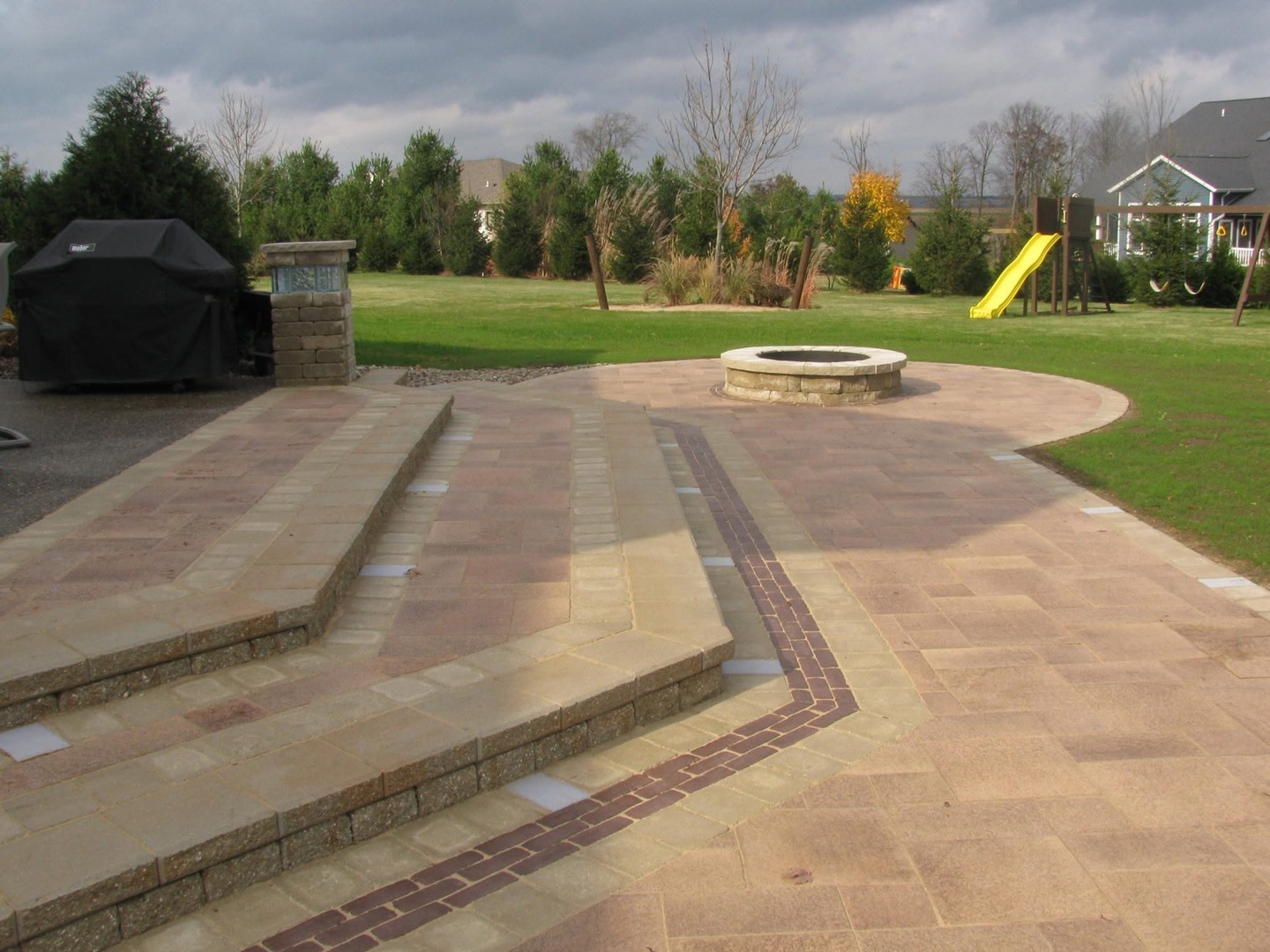 Covered porch with paver patio and fire pit in Platteville, WI